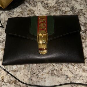Gucci Black Leather Clutch with Gold and Green Accents PREOWNED.